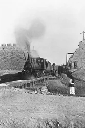 First train passing through the wall of Peking, China, c.1900